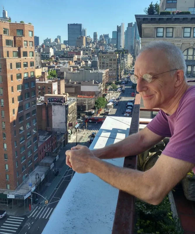 Eric leaning on a balcony